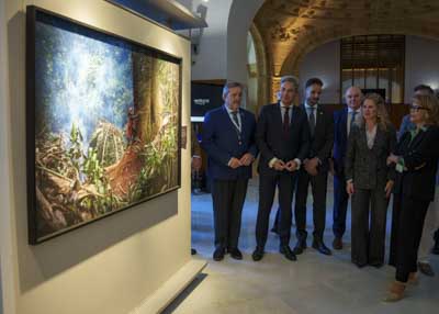 La autora de la muestra explica a los presentes una de las obras expuesta 